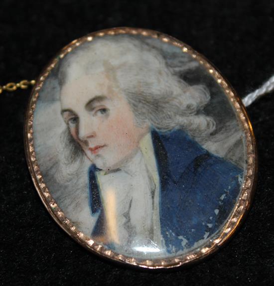 Early 19th century English School Miniature of a gentleman wearing a blue coat, 1.7 x 1.5in., gold brooch frame